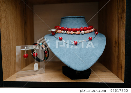 Shop window with necklaces and jewelry. Custome jewelry on display Shop window with necklaces and jewelry. Custome jewelry on display 92617860