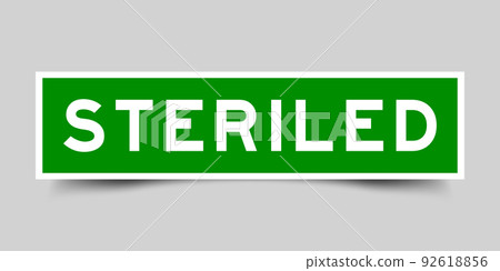 Green color square shape sticker label with word steriled on gray background 92618856