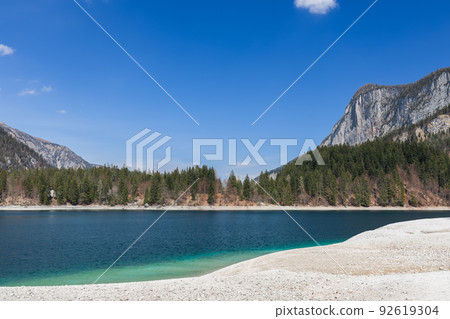 Blue sky is reflected in the emerald mineralized water of Tovel lake high in the mountains Blue sky is reflected in the emerald mineralized water of Tovel lake high in the mountains 92619304