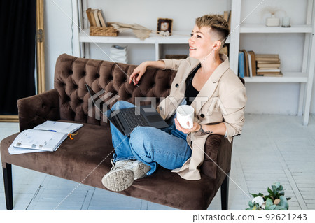 Start Own Business. Young trendy woman planning new project with papers and laptop in home office 92621243