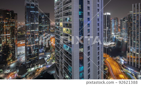 Tall residential buildings at JLT aerial night timelapse, part of the Dubai multi commodities centre mixed-use district. Tall residential buildings at JLT aerial night timelapse, part of the Dubai multi commodities centre mixed-use district. 92621388