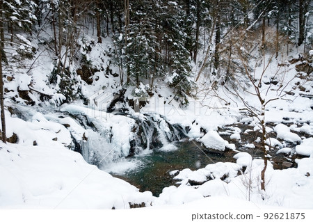 A small active waterfall. Clean mountain stream, snowy winter landscape, wildlife background A small active waterfall. Clean mountain stream, snowy winter landscape, wildlife background 92621875