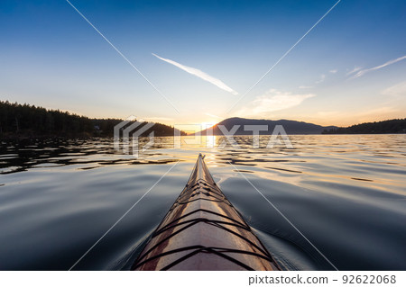 Sea Kayak paddling in the Pacific Ocean. Colorful Sunset Sky. 92622068