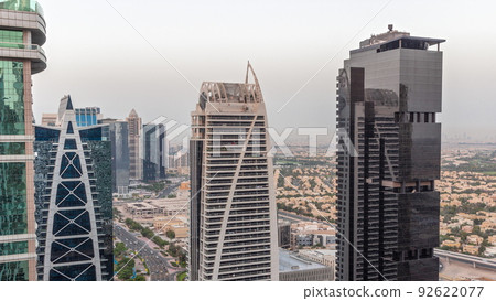 Tall residential buildings at JLT aerial day to night timelapse, part of the Dubai multi commodities centre mixed-use district. 92622077