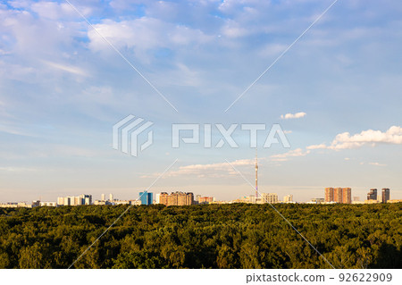 park and apartment houses on horizon at sunset 92622909