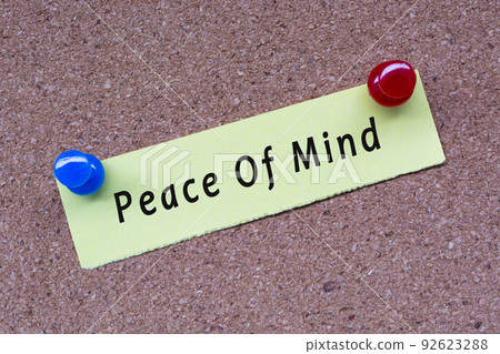 Peace of mind words on stick note and pinned to a cork notice board. Peace of mind words on stick note and pinned to a cork notice board. 92623288