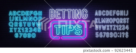 Betting tips neon sign on a brick background. 92623441