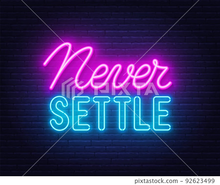 Never Settle l neon quote on a brick wall. 92623499