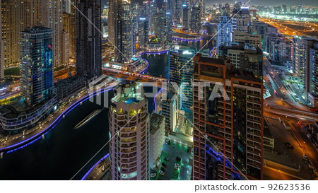 View of various skyscrapers in tallest recidential block in Dubai Marina aerial night timelapse 92623536