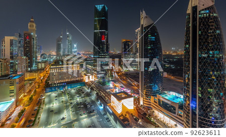 Aerial view of Dubai International Financial District with many skyscrapers night timelapse. 92623611