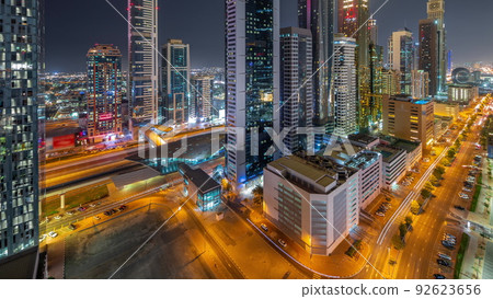 Aerial view of Dubai International Financial District with many skyscrapers night timelapse. Aerial view of Dubai International Financial District with many skyscrapers night timelapse. 92623656