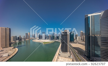 Cityscape skyscrapers of Dubai Business Bay with water canal aerial timelapse. 92623707