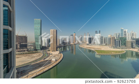 Cityscape skyscrapers of Dubai Business Bay with water canal aerial timelapse. 92623708