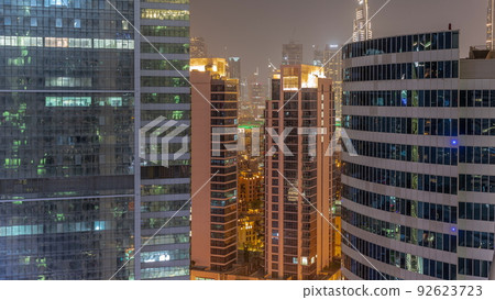 Skyscrapers in Dubai Business Bay and financial district aerial night timelapse. 92623723