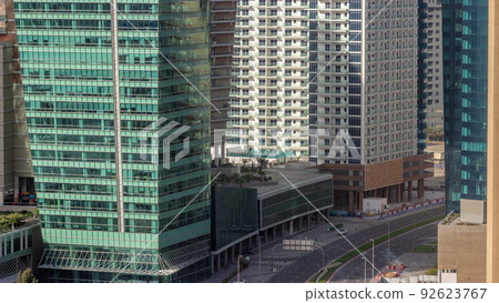 Dubai business bay district with office skyscrapers and traffic on the road intersection aerial timelapse. Dubai business bay district with office skyscrapers and traffic on the road intersection aerial timelapse. 92623767