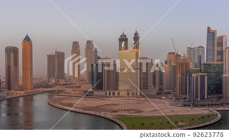 Cityscape skyscrapers of Dubai Business Bay with water canal aerial timelapse. 92623778