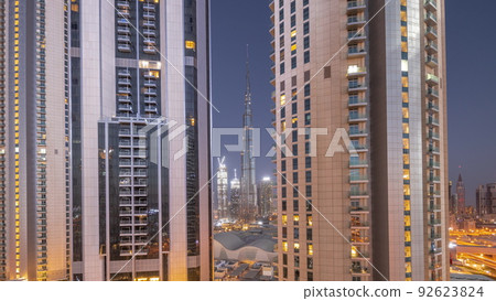 Tallest skyscrapers in downtown dubai located on bouleward street near shopping mall aerial night to day timelapse. Tallest skyscrapers in downtown dubai located on bouleward street near shopping mall aerial night to day timelapse. 92623824