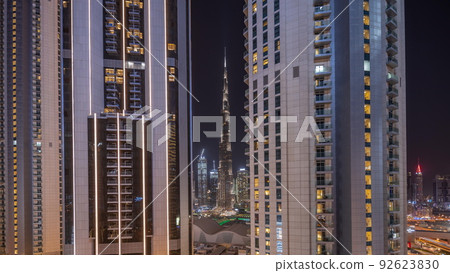 Tallest skyscrapers in downtown dubai located on bouleward street near shopping mall aerial night timelapse. 92623830