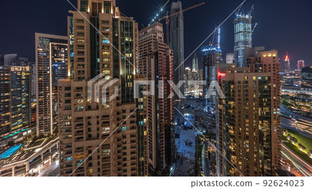 Aerial cityscape night timelapse with illuminated architecture of Dubai downtown. Aerial cityscape night timelapse with illuminated architecture of Dubai downtown. 92624023