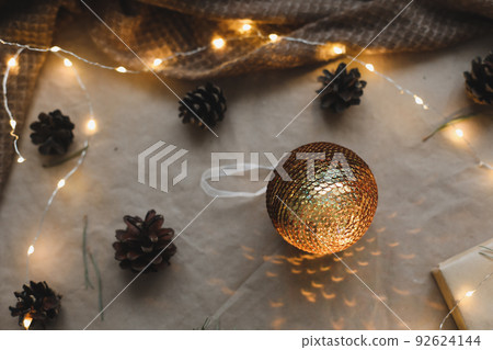 Christmas composition on craft paper background with gift box, fir branches, toys, copy space for your congratulations 92624144