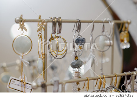 Shop window with necklaces and jewelry. Custome jewelry on display Shop window with necklaces and jewelry. Custome jewelry on display 92624352