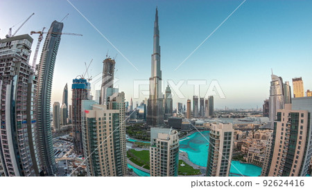 Dubai Downtown cityscape with tallest skyscrapers around aerial day to night timelapse. 92624416