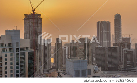 Aerial sunrise over big futuristic city timelapse. Business bay and Downtown 92624566