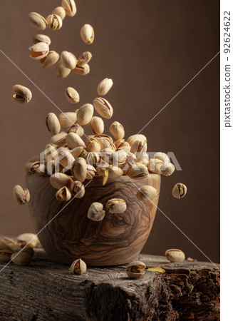 Flying salted pistachios. 92624622