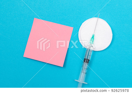 Vaccination or Revaccination Concept - A Medical Syringe on Blue Table Vaccination or Revaccination Concept - A Medical Syringe on Blue Table 92625978