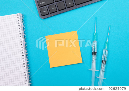 Vaccination or Revaccination Concept - Two Medical Syringe on Blue Table 92625979