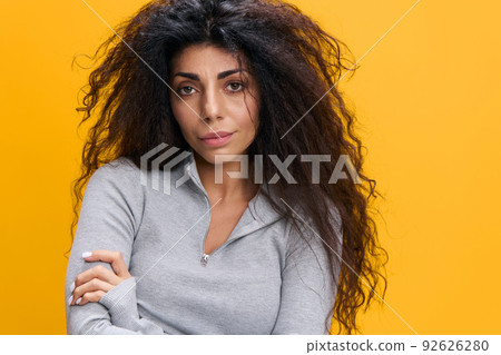 Young serious disappointed displeased dissatisfied caucasian woman 20s in pastel gray clothes hold hands crossed folded isolated on orange background studio portrait. People lifestyle concept Young serious disappointed displeased dissatisfied caucasian woman 20s in pastel gray clothes hold hands crossed folded isolated on orange background studio portrait. People lifestyle concept 92626280