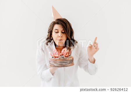 a lilt woman with a birthday cake with candles. 92626412