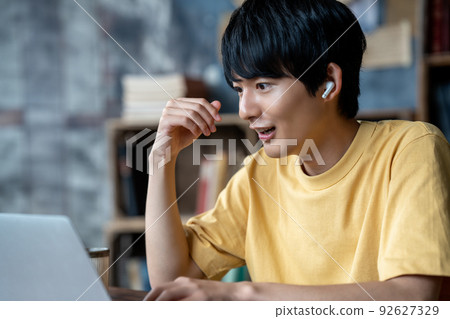 Young man having an internet conference in a chic room 92627329