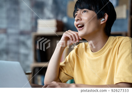 Young man having an internet conference in a chic room 92627333