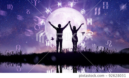 Astrological zodiac signs inside of horoscope circle. Couple singing and dancing over the zodiac wheel and milky way background. The power of the universe concept. 92628031