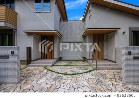 Gate and entrance of a two-family house 92628603