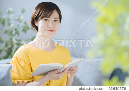 A woman reading A woman reading 92630576