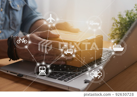 Hand of Casual Businessman Catch Parcel on Laptop and Logistic Icon Hand of Casual Businessman Catch Parcel on Laptop and Logistic Icon 92630728