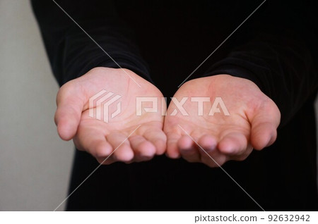 person holding out palms of both hands 92632942