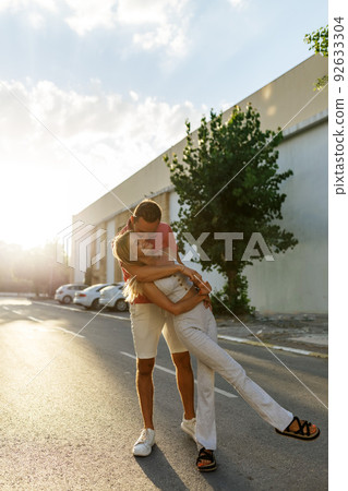 Couple has fun and laughs. Young hipster couple hugging each other in city. Summer love story, beautiful stylish young couple. Spring fashion urban concept with boyfriend and girlfriend. Select focus 92633304
