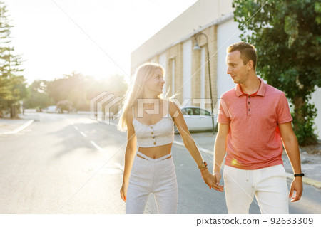 Couple has fun and laughs. Young hipster couple hugging each other in city. Summer love story, beautiful stylish young couple. Spring fashion urban concept with boyfriend and girlfriend. Select focus 92633309