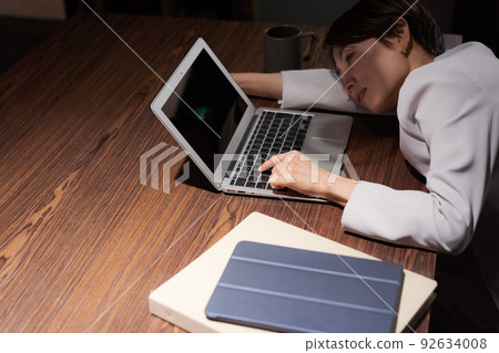 A woman tired from work 92634008