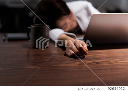 A woman tired from work A woman tired from work 92634012