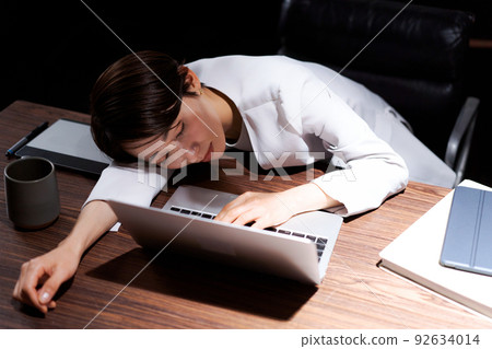 A woman tired from work A woman tired from work 92634014