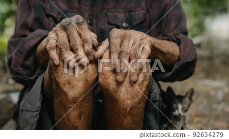 Close up of male wrinkled hands, old man is wearing. Close up of male wrinkled hands, old man is wearing. 92634279