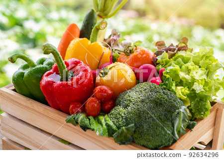 Wooden crate filled with fresh organic vegetables in morning light. . Wooden crate filled with fresh organic vegetables in morning light. . 92634296