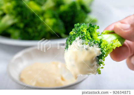Add mayonnaise to boiled broccoli 92634871