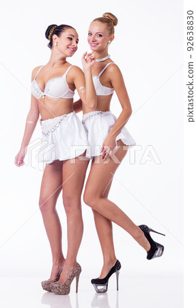 Female duo in studio. Two girls hug at dark background. Sensual models in lingerie. Female duo in studio. Two girls hug at dark background. Sensual models in lingerie. 92638830