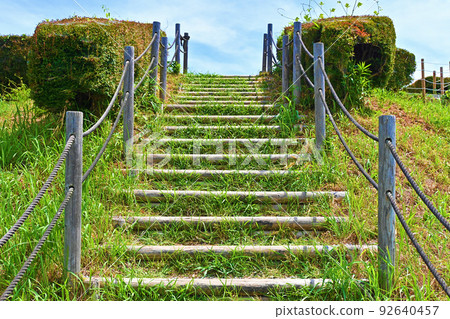 Ascending stairs with poles on both sides 92640457