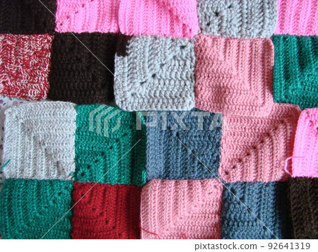 Crochet texture, colorful squares pattern. Crochet Knit Squares Crochet texture, colorful squares pattern. Crochet Knit Squares 92641319